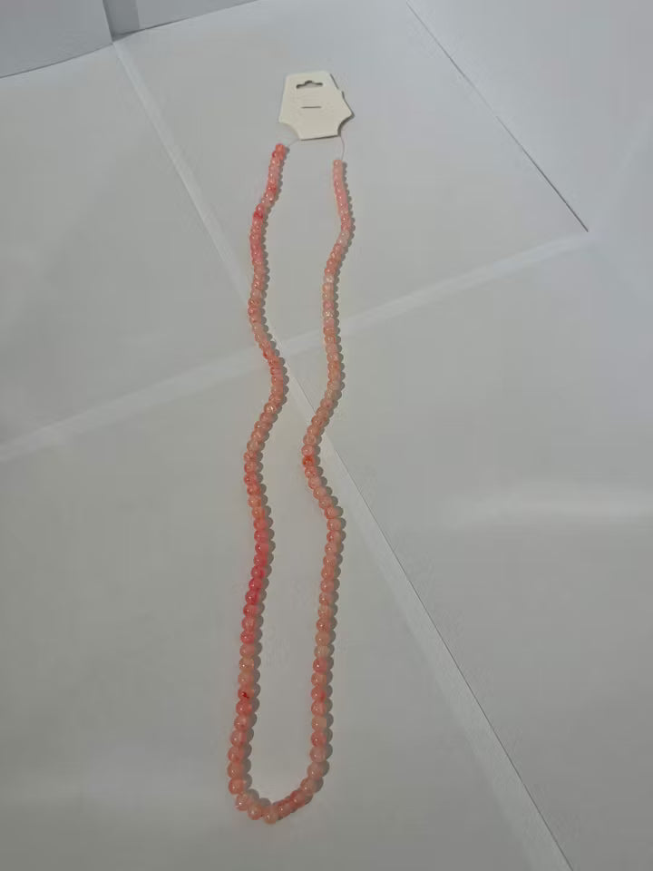 Sträng med glaspärlor i färgen Orang/Rosa färg 6mm (133st)