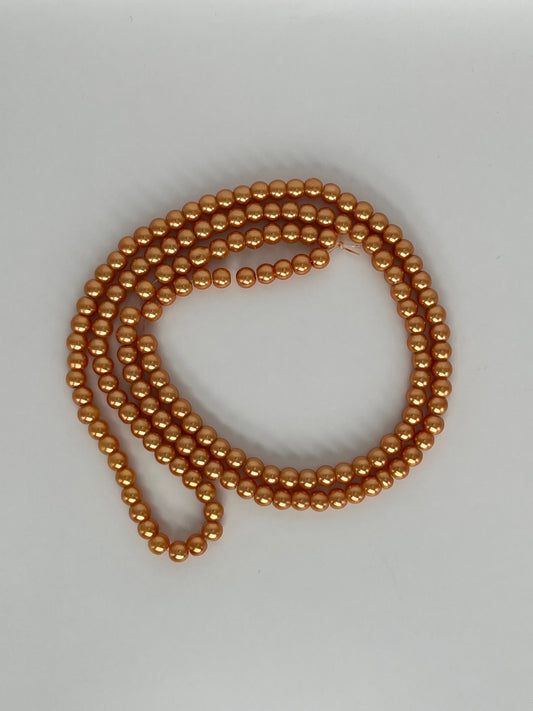 Sträng med vaxade glaspärlor ljusorange, 6mm