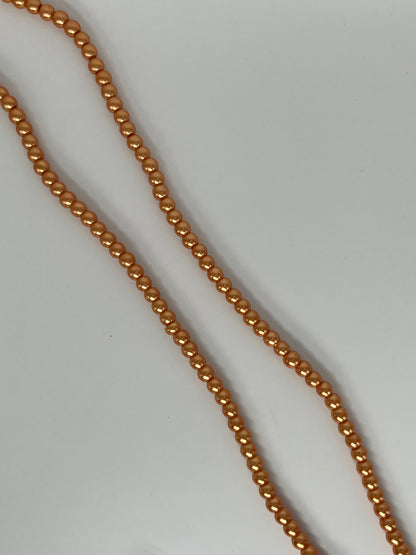 Sträng med vaxade glaspärlor ljusorange, 6mm